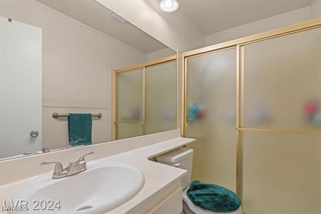 full bathroom with an enclosed shower, a sink, and toilet