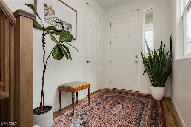 entrance foyer featuring wood finished floors and baseboards