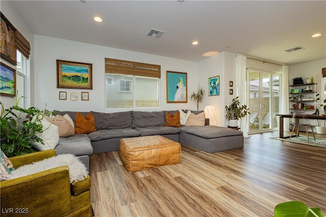 living area featuring light wood-style flooring, visible vents, and recessed lighting