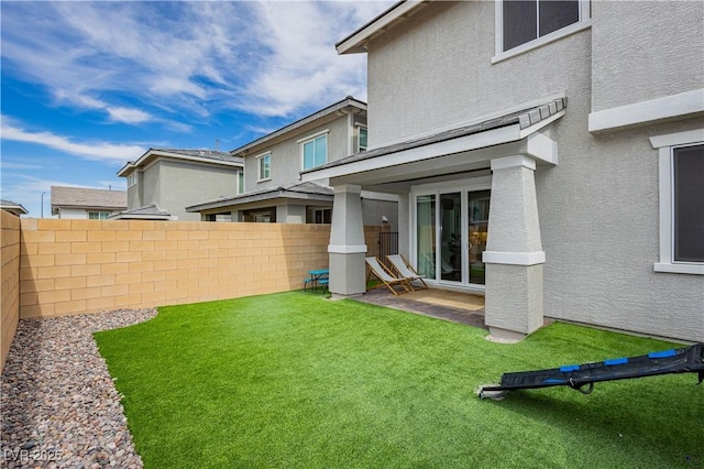 view of yard featuring fence and a patio