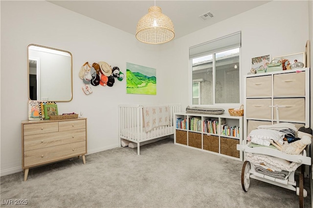 bedroom featuring a crib, carpet, visible vents, and baseboards