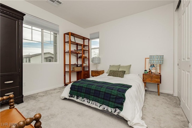 bedroom featuring light carpet, a closet, visible vents, and baseboards