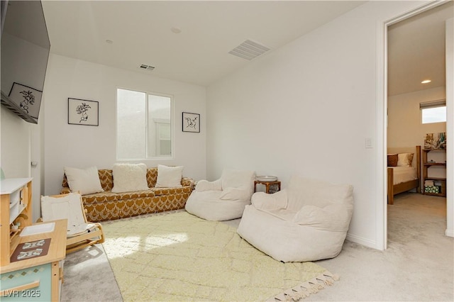 living room with light carpet and visible vents