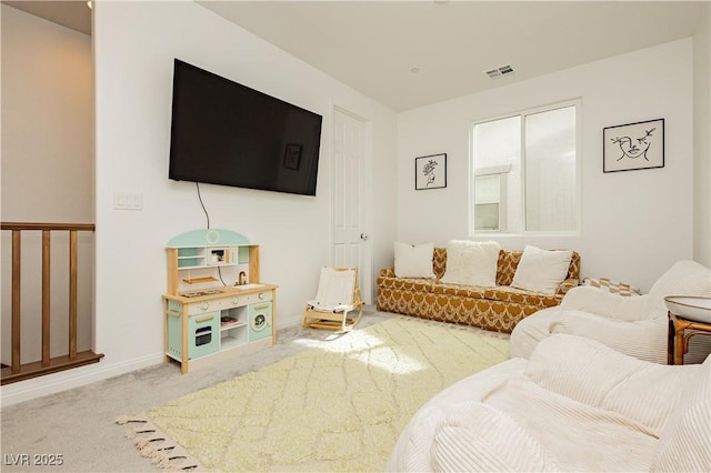 living area featuring carpet flooring, visible vents, and baseboards