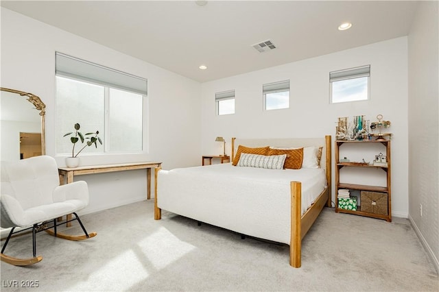 bedroom featuring recessed lighting, light carpet, and multiple windows