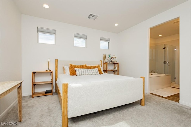 bedroom featuring light carpet, ensuite bath, visible vents, and recessed lighting