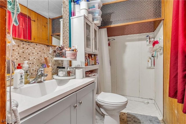 bathroom featuring decorative backsplash, toilet, vanity, and tile patterned flooring