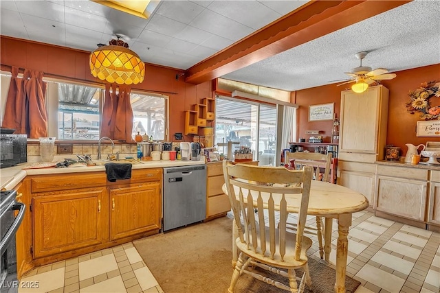 kitchen featuring plenty of natural light, range, black microwave, and stainless steel dishwasher