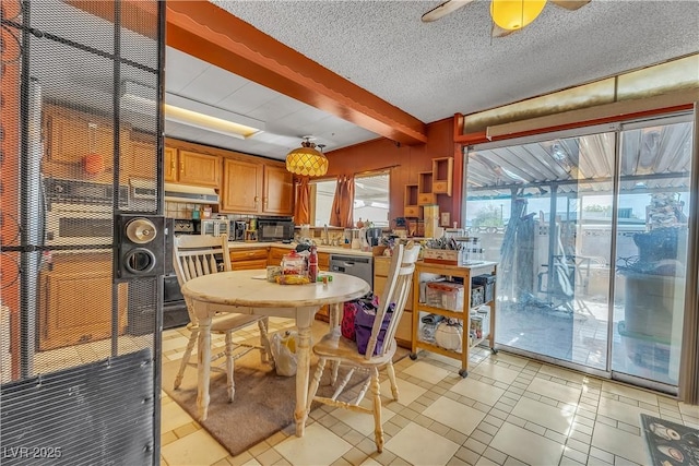 dining space featuring beamed ceiling, a ceiling fan, and a textured ceiling