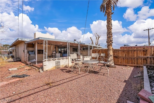 rear view of house featuring outdoor dining area and a patio