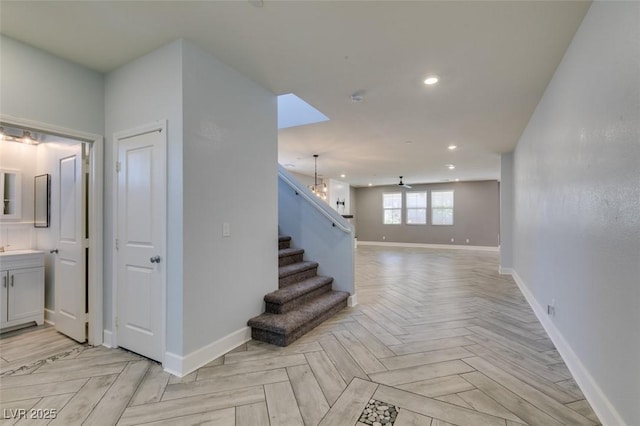 stairway featuring baseboards and recessed lighting