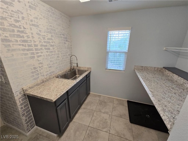 981 Soaring Moon Dr, Henderson, NV 89015 - laundry area featuring a sink, light tile patterned floors, and baseboards