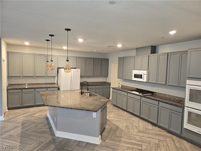 981 Soaring Moon Dr, Henderson, NV 89015 - kitchen with a sink, white appliances, gray cabinets, and recessed lighting