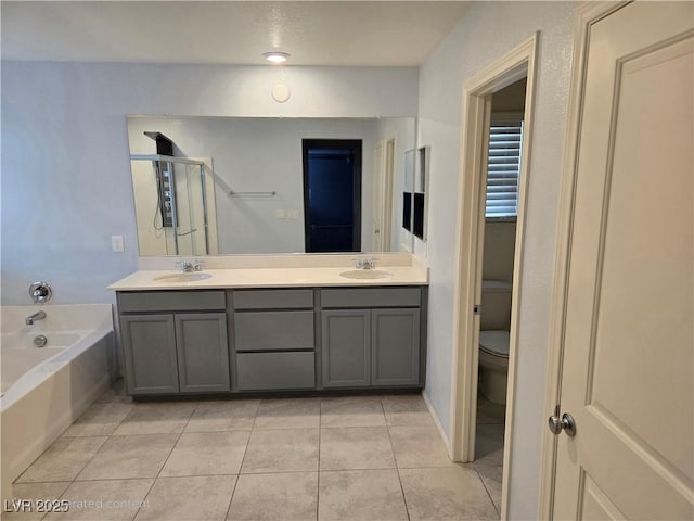 981 Soaring Moon Dr, Henderson, NV 89015 - bathroom with double vanity, toilet, a bath, tile patterned flooring, and a shower with door
