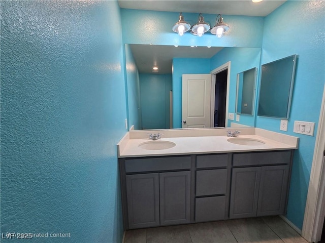 981 Soaring Moon Dr, Henderson, NV 89015 - full bath featuring double vanity, a textured wall, and tile patterned flooring