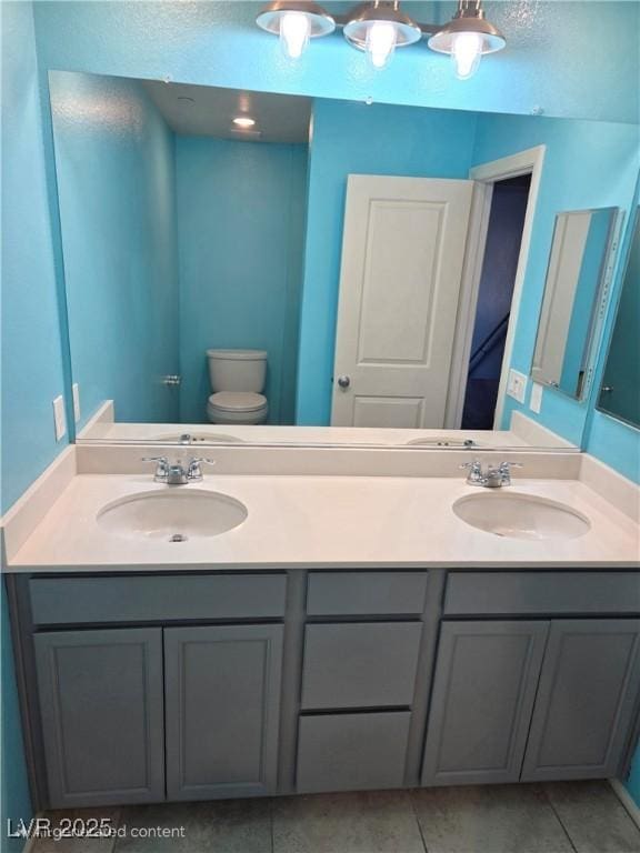 981 Soaring Moon Dr, Henderson, NV 89015 - bathroom with toilet, double vanity, and tile patterned flooring