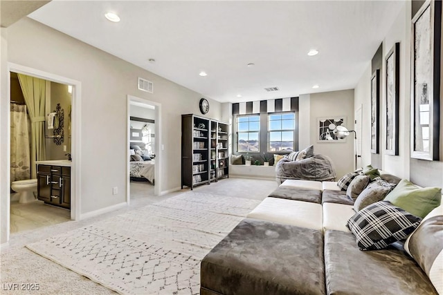 living area featuring recessed lighting, light colored carpet, and visible vents