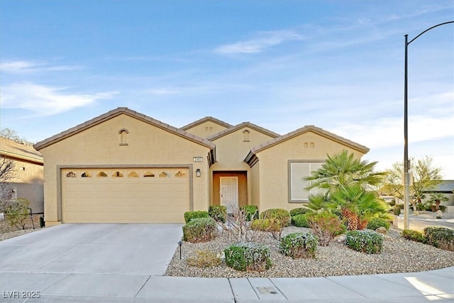 view of front of property with driveway, an attached garage, and stucco siding