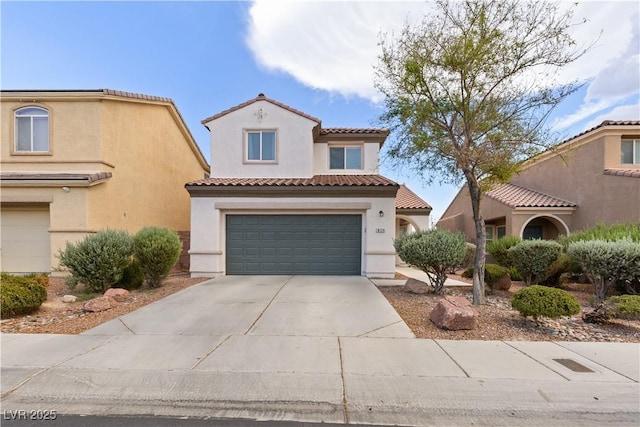 mediterranean / spanish-style home with concrete driveway, a tile roof, an attached garage, and stucco siding