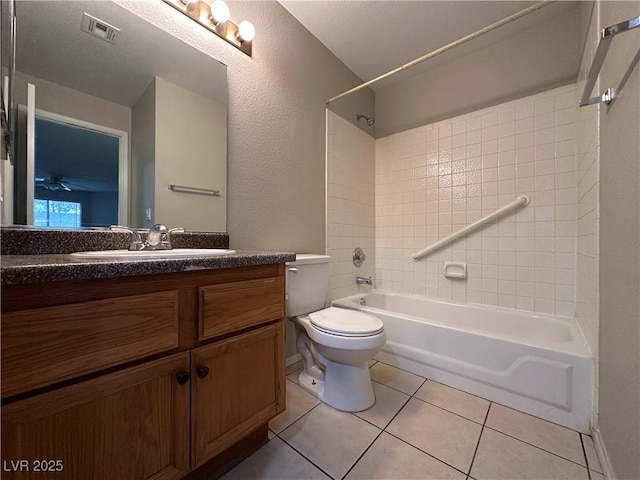 bathroom featuring shower / bathtub combination, visible vents, toilet, vanity, and tile patterned flooring