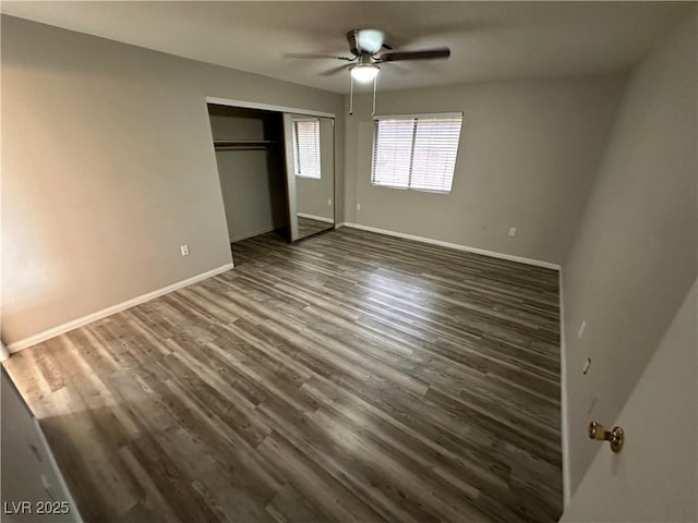 unfurnished bedroom with ceiling fan, baseboards, dark wood finished floors, and a closet