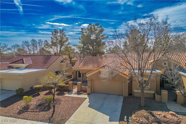 view of front of house featuring concrete driveway, an attached garage, a tiled roof, and stucco siding