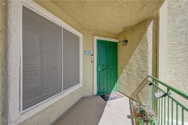 entrance to property featuring stucco siding