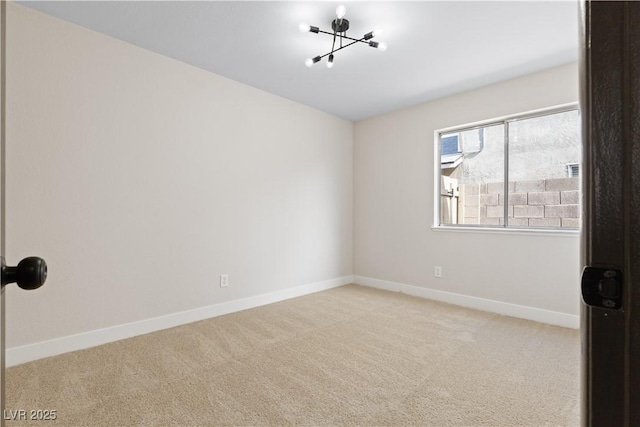 unfurnished room with baseboards and light colored carpet