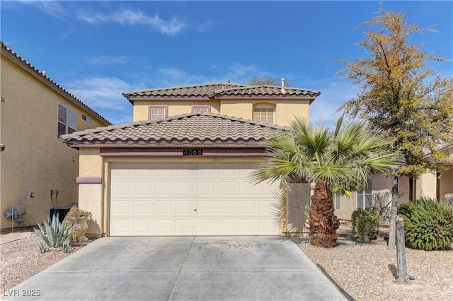 mediterranean / spanish-style home featuring central AC unit, concrete driveway, a tile roof, an attached garage, and stucco siding