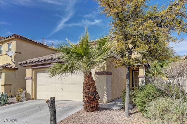 view of front of house featuring concrete driveway, an attached garage, a tile roof, and stucco siding