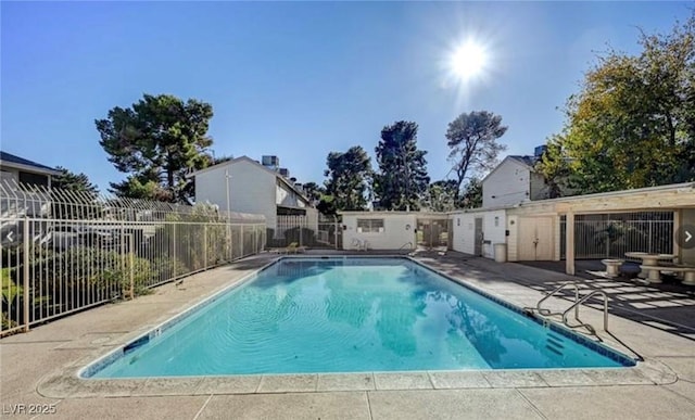 view of swimming pool featuring a patio area, fence, and a fenced in pool