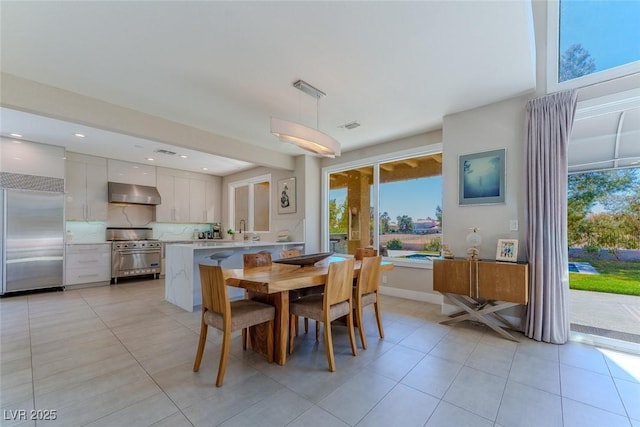 dining space with light tile patterned floors, visible vents, and recessed lighting