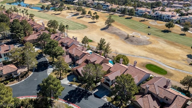 birds eye view of property with view of golf course, a water view, and a residential view