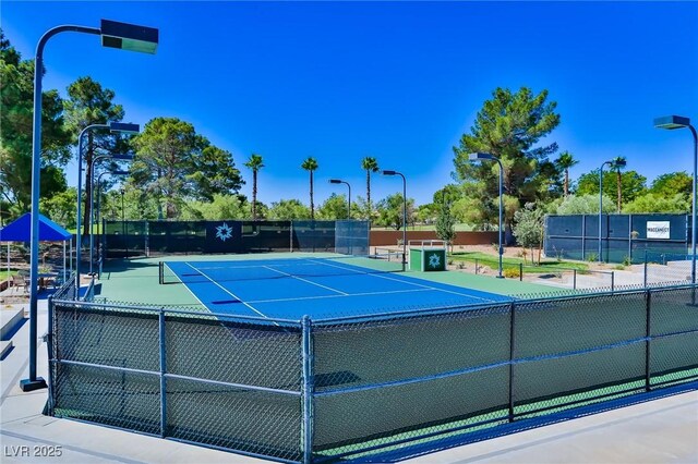 view of sport court featuring fence