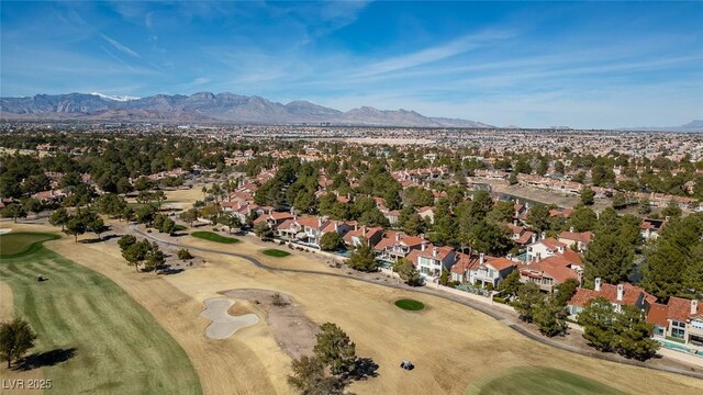 drone / aerial view featuring view of golf course, a residential view, and a mountain view