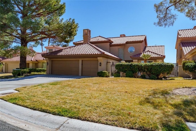 mediterranean / spanish home with stucco siding, concrete driveway, fence, a garage, and a front lawn