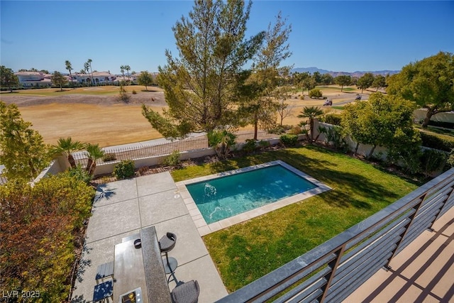 view of swimming pool with a fenced backyard, a mountain view, a lawn, a fenced in pool, and a patio area