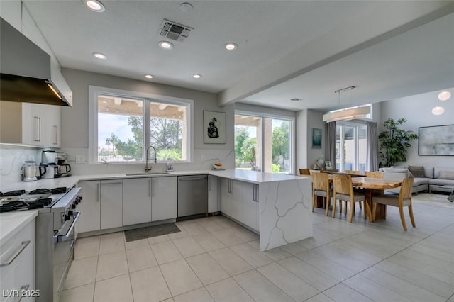 7999 Pinnacle Peak Ave, Las Vegas, NV 89113 - kitchen featuring extractor fan, appliances with stainless steel finishes, a sink, a peninsula, and recessed lighting