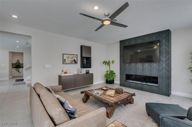 7999 Pinnacle Peak Ave, Las Vegas, NV 89113 - living area featuring a tiled fireplace, ceiling fan, recessed lighting, baseboards, and light tile patterned floors