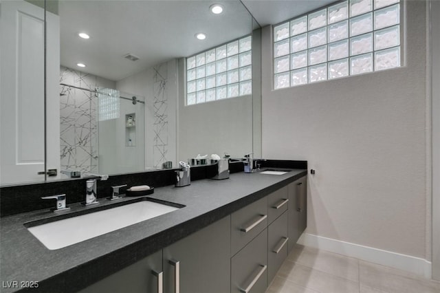 7999 Pinnacle Peak Ave, Las Vegas, NV 89113 - bathroom with baseboards, double vanity, a marble finish shower, recessed lighting, and tile patterned floors