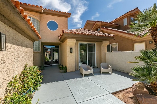 7999 Pinnacle Peak Ave, Las Vegas, NV 89113 - back of house featuring french doors, a tiled roof, stucco siding, and a patio area