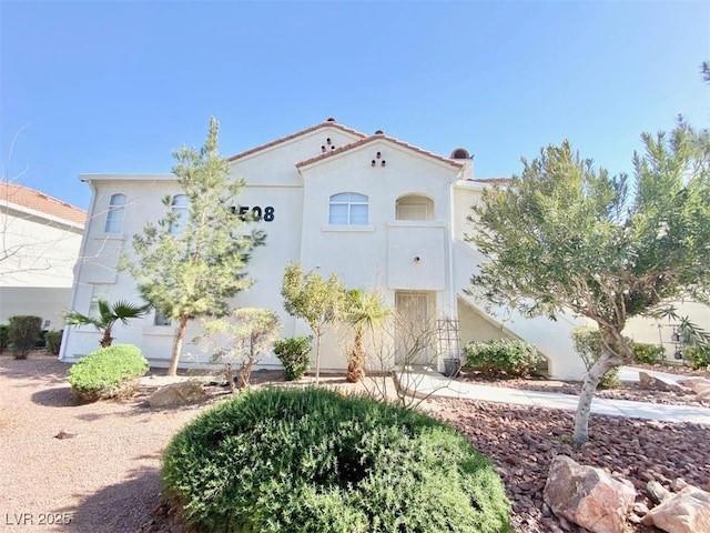 view of front of home featuring a tile roof and stucco siding