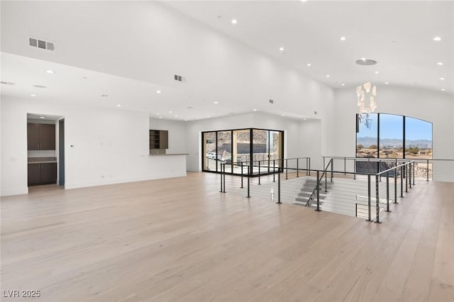 empty room featuring recessed lighting, visible vents, and light wood finished floors