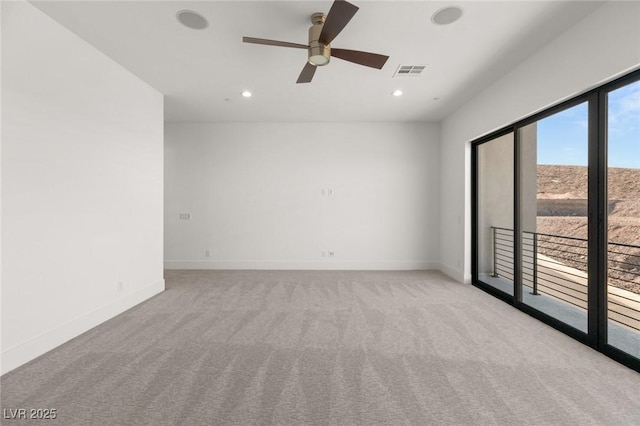 empty room with baseboards, visible vents, light colored carpet, ceiling fan, and recessed lighting