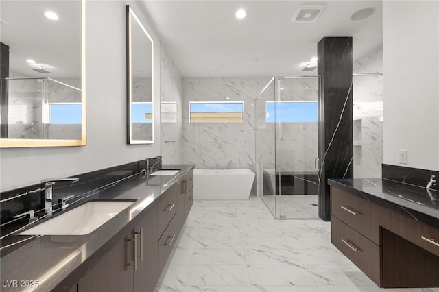 full bath with recessed lighting, a sink, marble finish floor, a soaking tub, and a marble finish shower