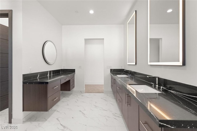 bathroom with marble finish floor, vanity, and recessed lighting