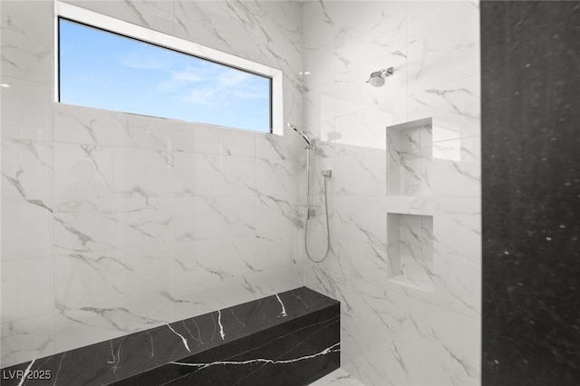 bathroom with a marble finish shower