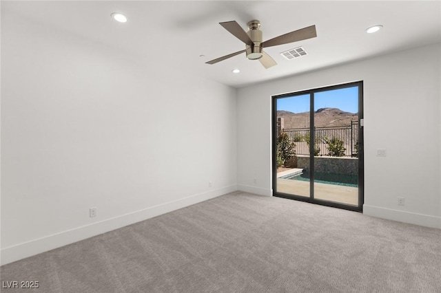 empty room with baseboards, visible vents, light colored carpet, ceiling fan, and recessed lighting