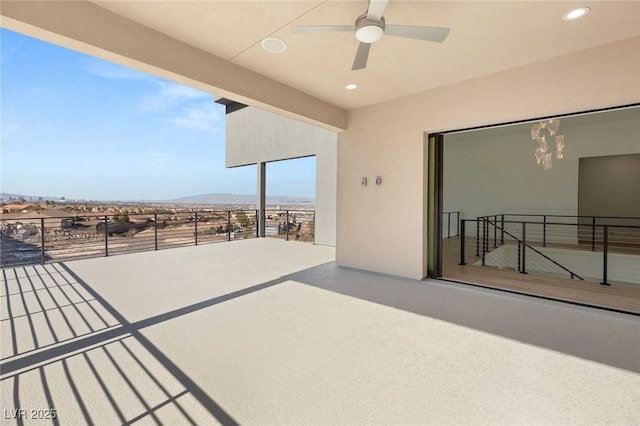 view of patio / terrace with ceiling fan and a mountain view