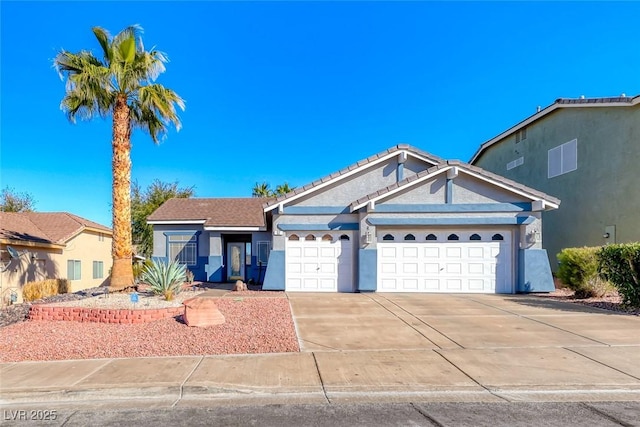 single story home with a garage, concrete driveway, and stucco siding